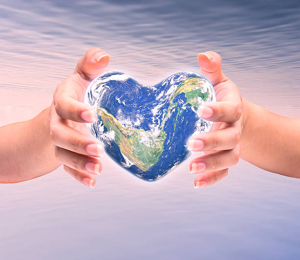 istock World in heart shape with over women human hands 509179038