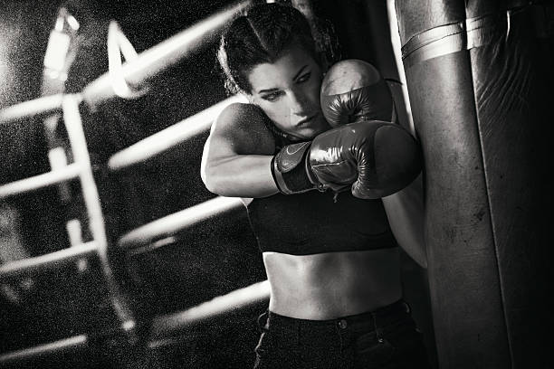 istock Female boxer training with a punching bag 509179224
