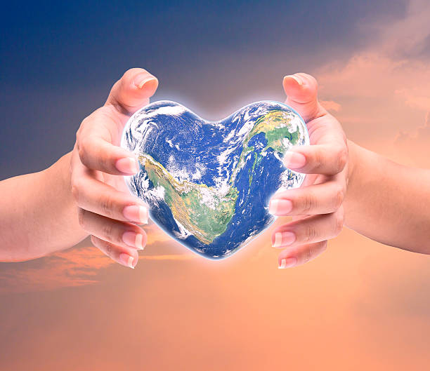 istock World in heart shape with over women human hands 509179278