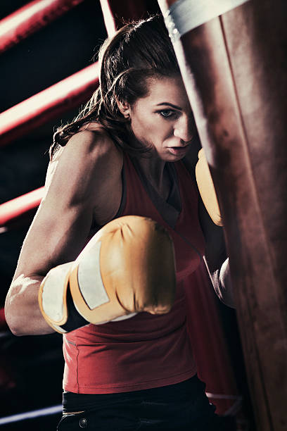 istock Female boxer training with a punching bag 509179368