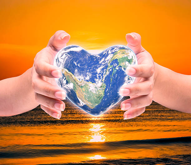 istock World in heart shape with over women human hands 509179450