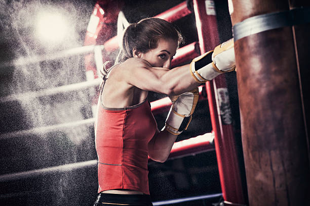 istock Female boxer training with a punching bag 509179468