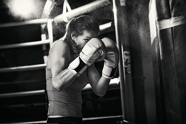 Female boxer training with a punching bag