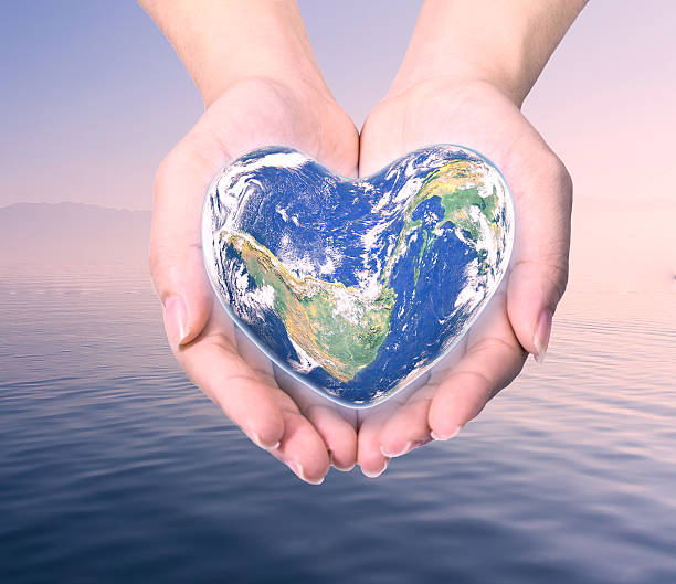 istock World in heart shape with over women human hands 509179708