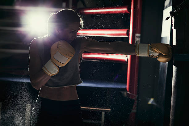 istock Female boxer training with a punching bag 509180102
