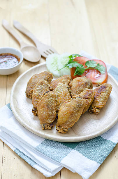 istock Fired chicken wings on wood plate with thai dip 509183548
