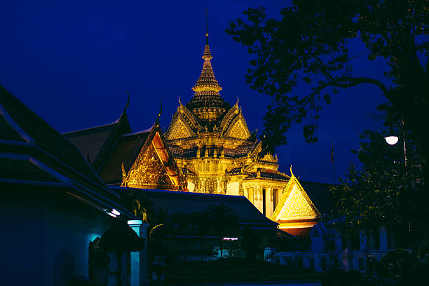 Temple rooftops at night in Wat Pho, Bangkok, Thailand, Beautiful blue sunset that night with overcast clouds.