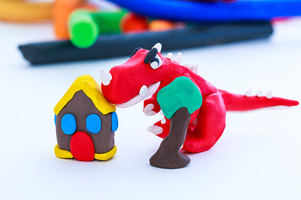 istock Creative dinosaur, house and tree clay model, on white backgroun 509184608
