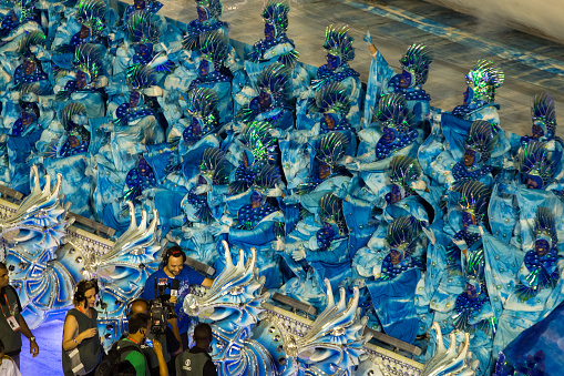 Rio de Janeiro, Brazil - February 09, 2016: Rede Globo reporter interviewing floatees that are dressed in blue, like sea waves, during the carnival parade.