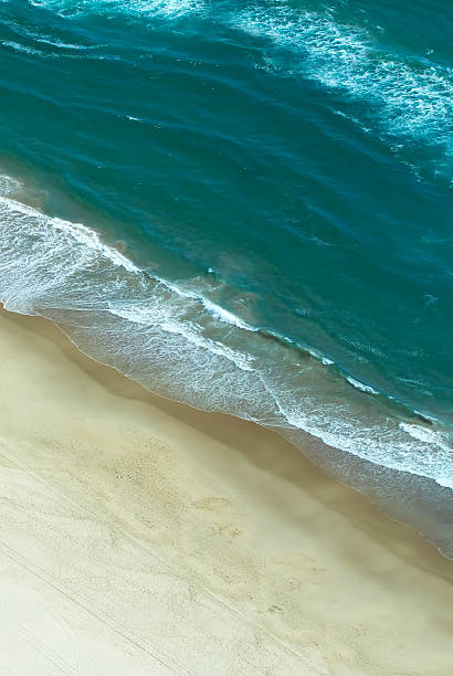 istock Aerial view of waves crashing on beach vertical image 509185780