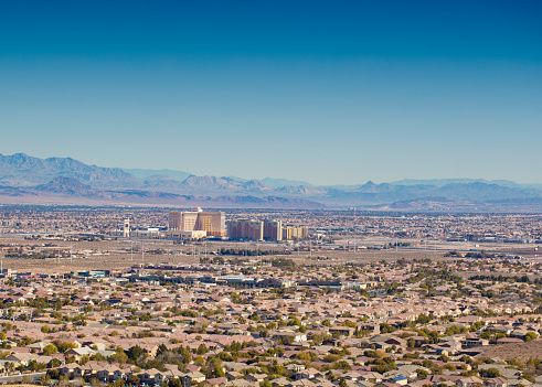 Las Vegas, USA - February 6, 2016: A stock photograph showing the many homes of Southern Highlands in Las Vegas, Nevada. Southern Highlands is masterplan community in the South West area of the Las Vegas Valley.  You can also see the South Point Hotel and Casino in the Distance. 