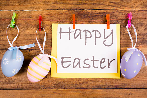 istock Easter eggs ornaments hang on rustic wood. Seasonal background. 509191872