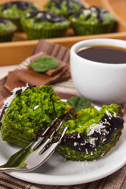 istock Muffins with spinach, desiccated coconut, chocolate glaze, cup of coffee 509192558