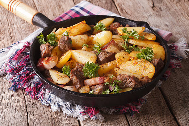 istock country fried potatoes with meat and bacon in pan closeup 509193392
