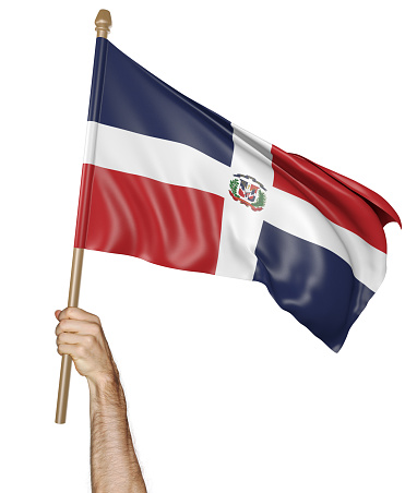Man's hand raising the Dominican Republic national flag high in the air, isolated against a white background.
