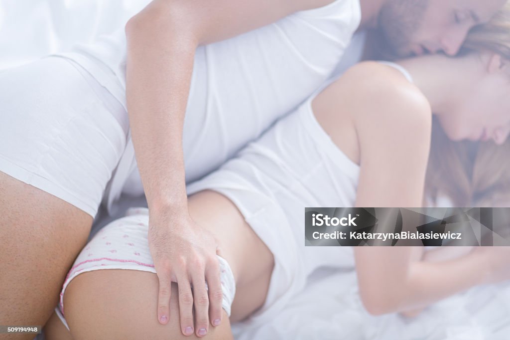 Married couple embracing in bed Married couple embracing in bed at the morning Bed - Furniture Stock Photo