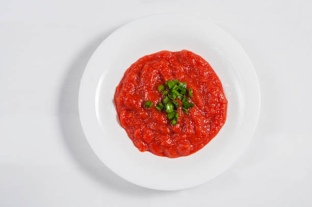 istock Tomato soup in a white bowl isolated background. Top view 509195656