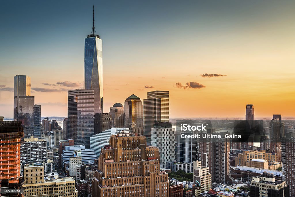 Lower Manhattan at sunset Lower Manhattan skyline at sunset with Freedom Tower standing tall above the skyline New York City Stock Photo