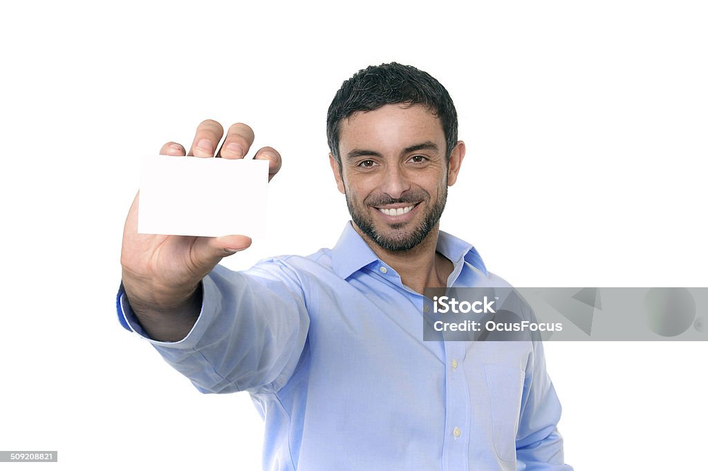 young attractive businessman holding blank business card happy handsome business man holding blank business card for adding corporate text company name or logo using empty card as copy space isolated on white blackground wearing beard and blue smart casual shirt Men Stock Photo