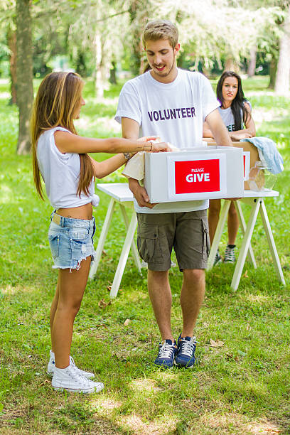 istock Group of volunteers with donation boxes 509211699