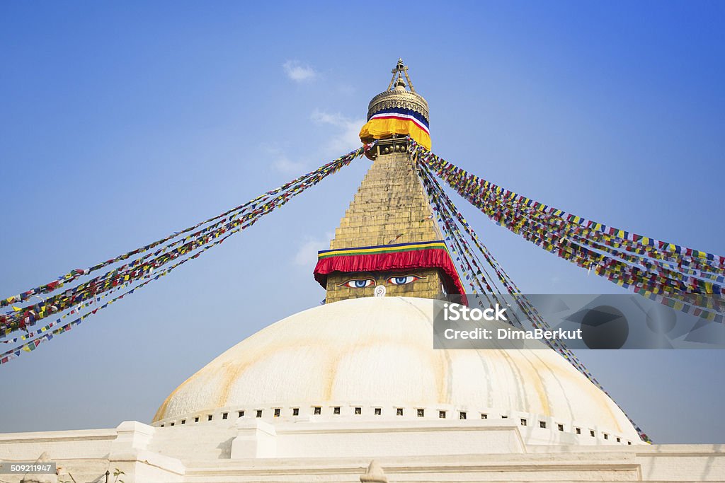 Bodhnath Stupa with buddha eyes, Kathmandu, Nepal. Bodhnath Stupa with buddha eyes and prayer flags, clear blue sky, Kathmandu, Nepal. Architecture Stock Photo