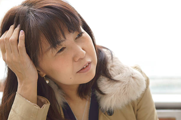 istock middle aged woman with head in hand 509226368