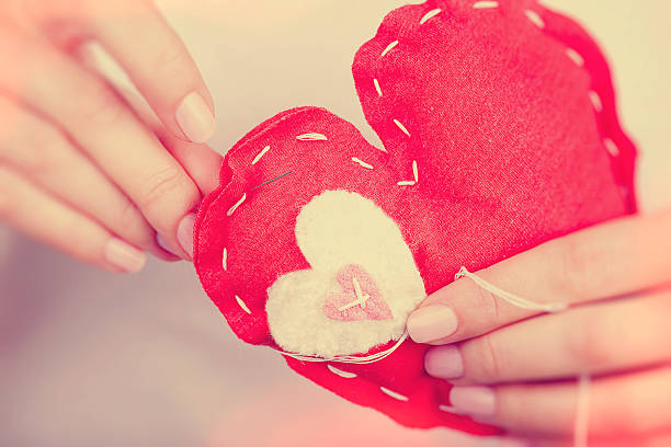 Fabric heart hanging on wooden surface