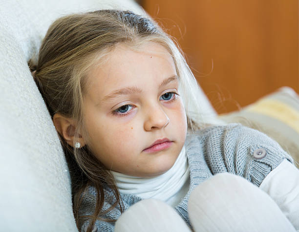 istock Miserable female child posing in couch at home 509227348