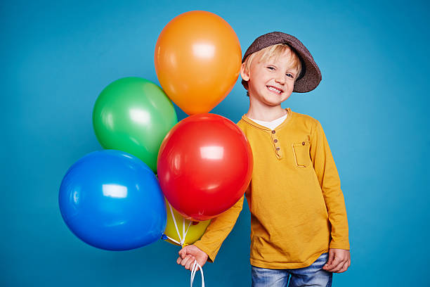 istock Cute boy with colorful balloons 509228986