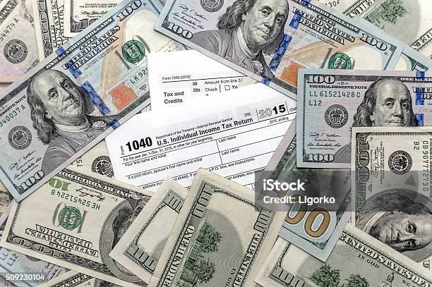 Tax Form 1040 With Us Dollar Bills Stock Photo - Download Image Now - Refund, Tax, Tax Form