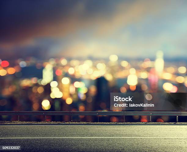 Asphalt Road And Blurred Modern City Stock Photo - Download Image Now - Abstract, Architecture, Asphalt