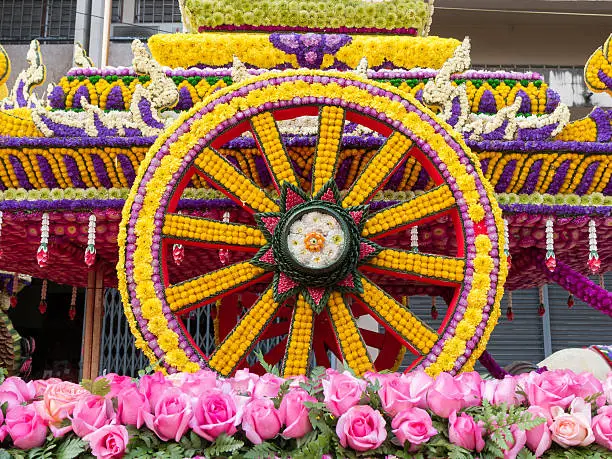 Photo of Wheel of cart is made from flowers (Flower Festival, Thailand)