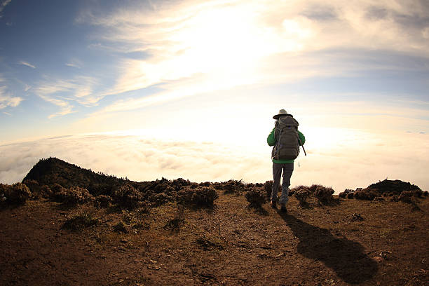 istock young woman backpacker hiking at beautiful mountain peak 509233410