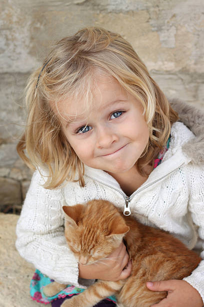 Smiling child with kitten stock photo