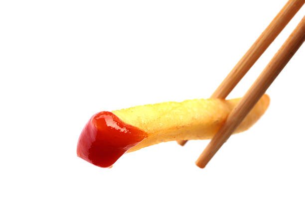 Close up image of dipping fried potato on white background stock photo