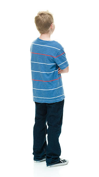 istock Rear view of little boy standing with arms crossed 509234792