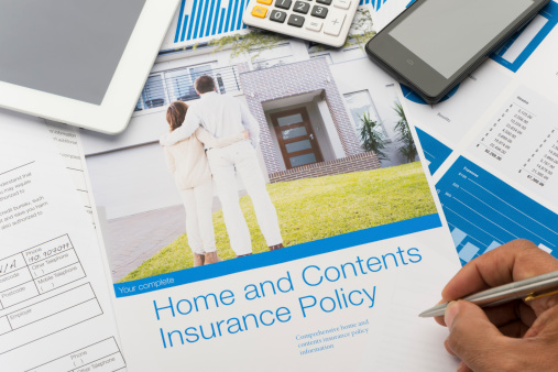 Home and contents insurance document with paperwork and technology. The included image can also be found in my portfolio. Image  #26822047