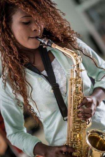 Black woman playing the saxophone