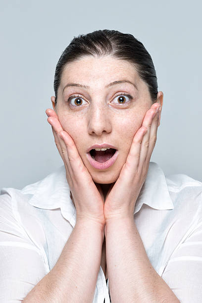 istock real young woman surprised portrait isolated on grey 509237030