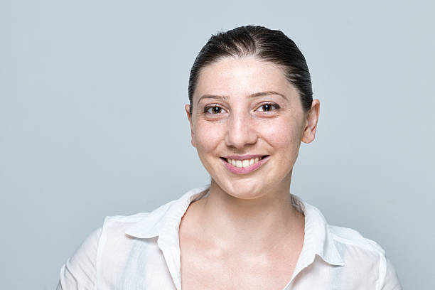 istock real young woman smiling portrait isolated on grey 509237134