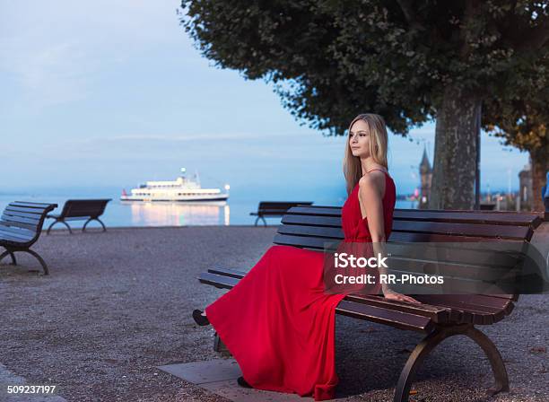 Giovane Bionda Donna Seduta Al Tramonto Sulla Promenade Constance - Fotografie stock e altre immagini di Acqua