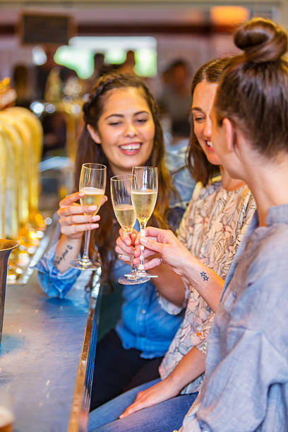 istock Young Women Celebrating With Champage in a Bar 509237556