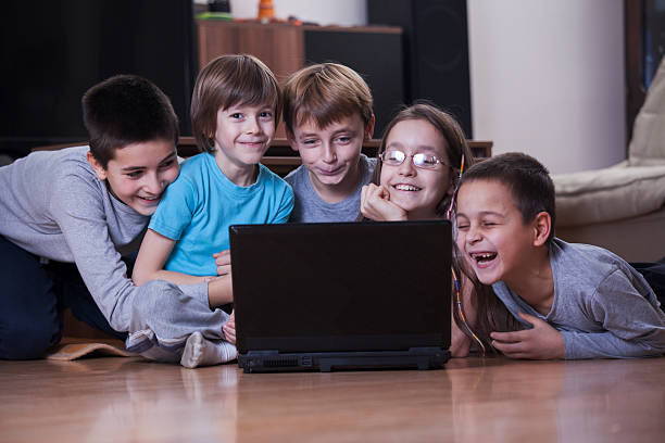 istock Children laughing while they looking in laptop 509239386