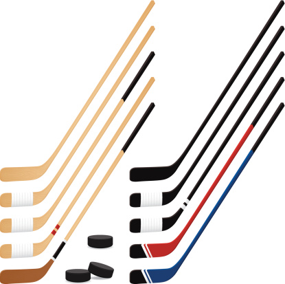 Hockey Puck and Sticks. Wooden hockey sticks created with transparency in Adobe Illustrator 10.