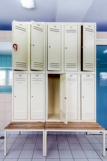 Interior of a locker room with rows of boxes and benches