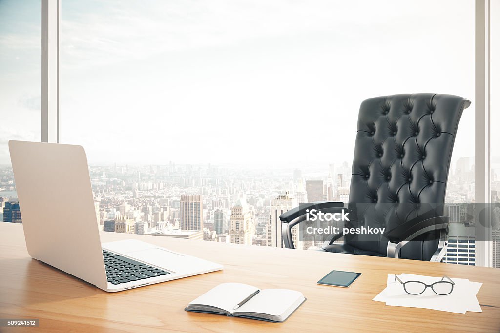 Workplace of the head with a laptop and Workplace of the head with a laptop and a classic leather armchair Office Chair Stock Photo