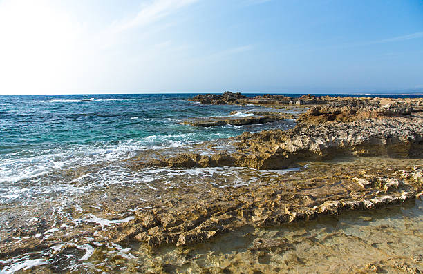 istock Sea waves with foam on the stony shore 509243606
