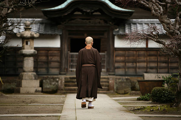 Buddhist monk in Kamakura, Japan. Kamakura, Japan - March 23, 2009: The buddhist monk in courtyard of a monastery in Kamakura, Japan. buddhist house of worship stock pictures, royalty-free photos & images
