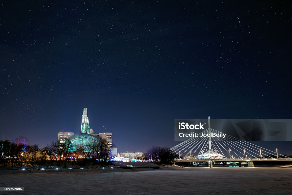 Winnipeg Manitoba City of Winnipeg skyline at night in winter.  Esplanade RIel and the Canadian Museum for Human Rights in view. Winnipeg Stock Photo