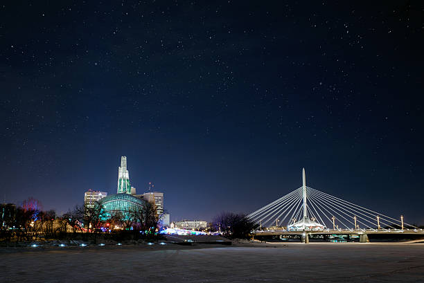 Winnipeg Manitoba City of Winnipeg skyline at night in winter.  Esplanade RIel and the Canadian Museum for Human Rights in view. winnipeg photos stock pictures, royalty-free photos & images